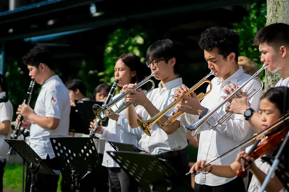 A group of people are playing instruments in an orchestra.