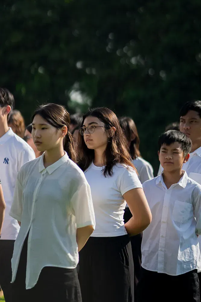 A group of young people are standing in a line.