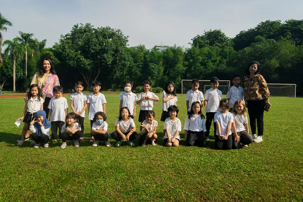 A group of children are posing for a picture in a field.