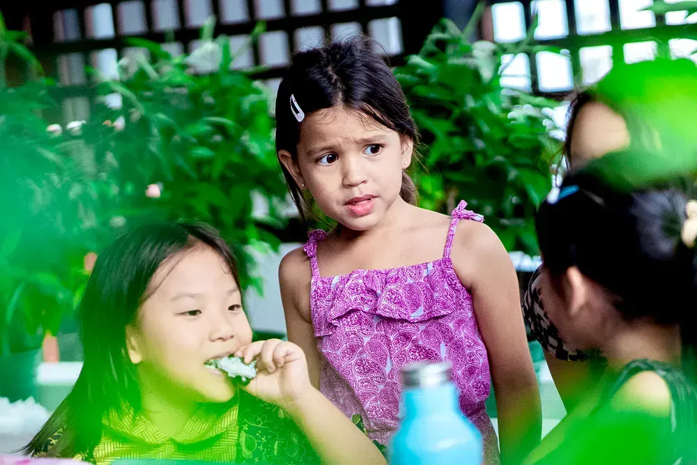 A group of young girls are brushing their teeth together.
