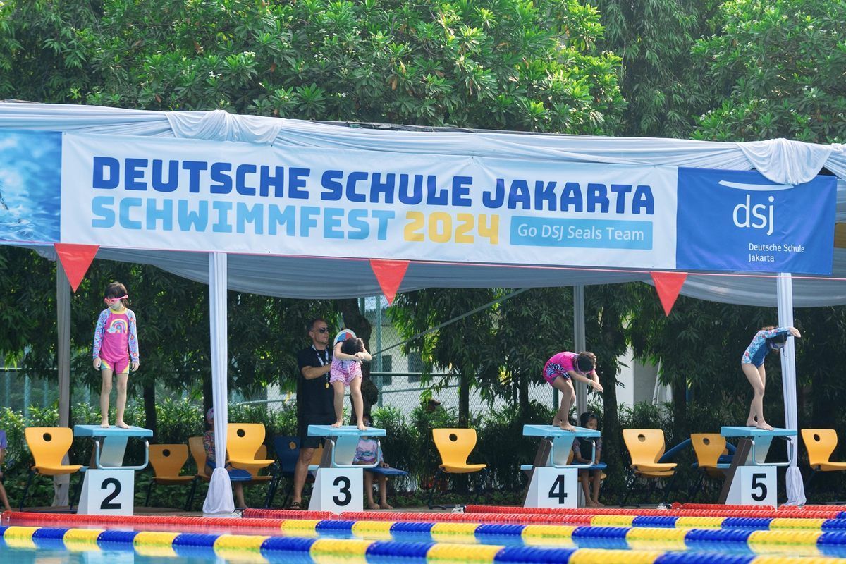 A swimming pool with a sign that says deutsche schule jakarta