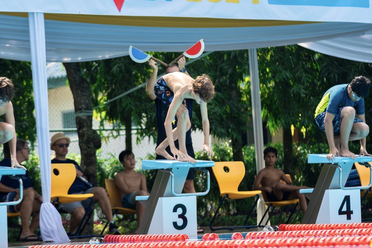 A group of kids are playing with watermelons in a swimming pool