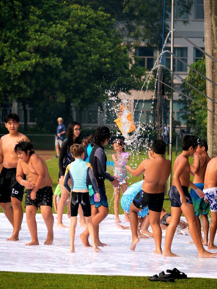 A group of people are playing in a pool of water