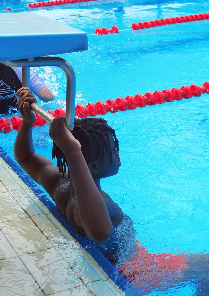A person is getting ready to swim in a pool