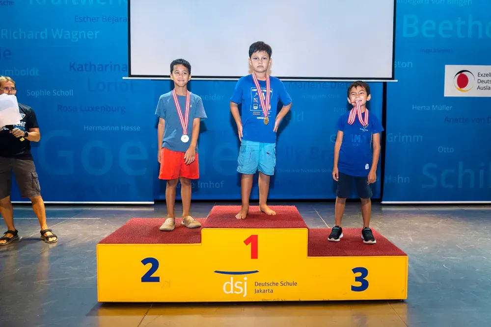 A group of young boys are standing on a podium.