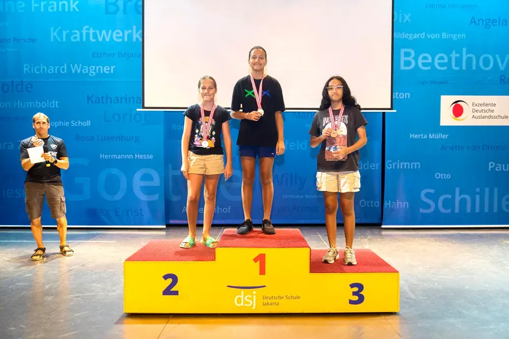 A group of people standing on a podium with the number 1 2 and 3 on it