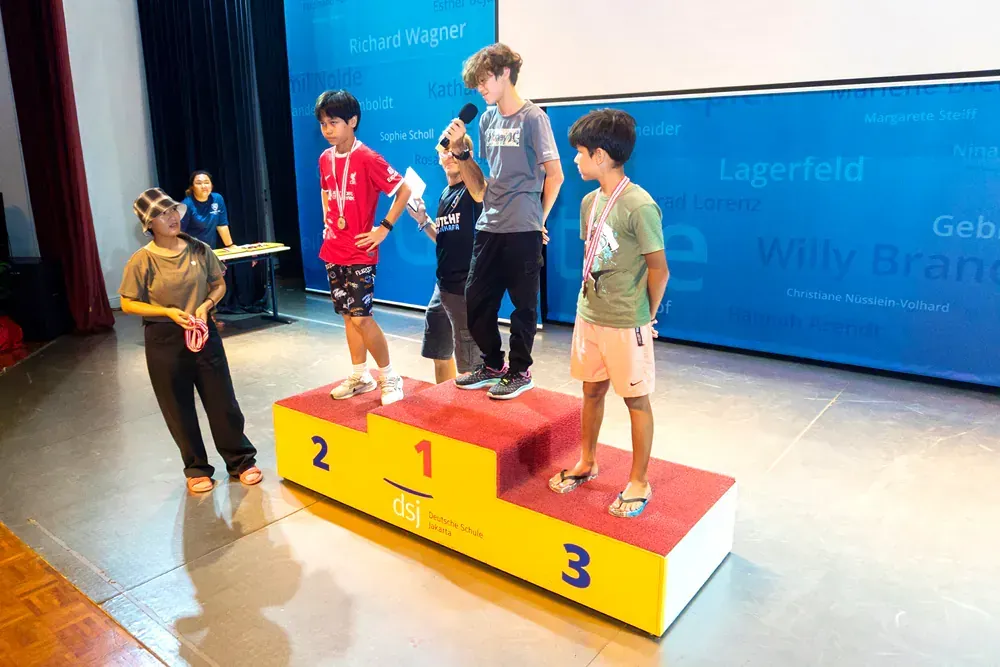 A group of young boys are standing on a podium.