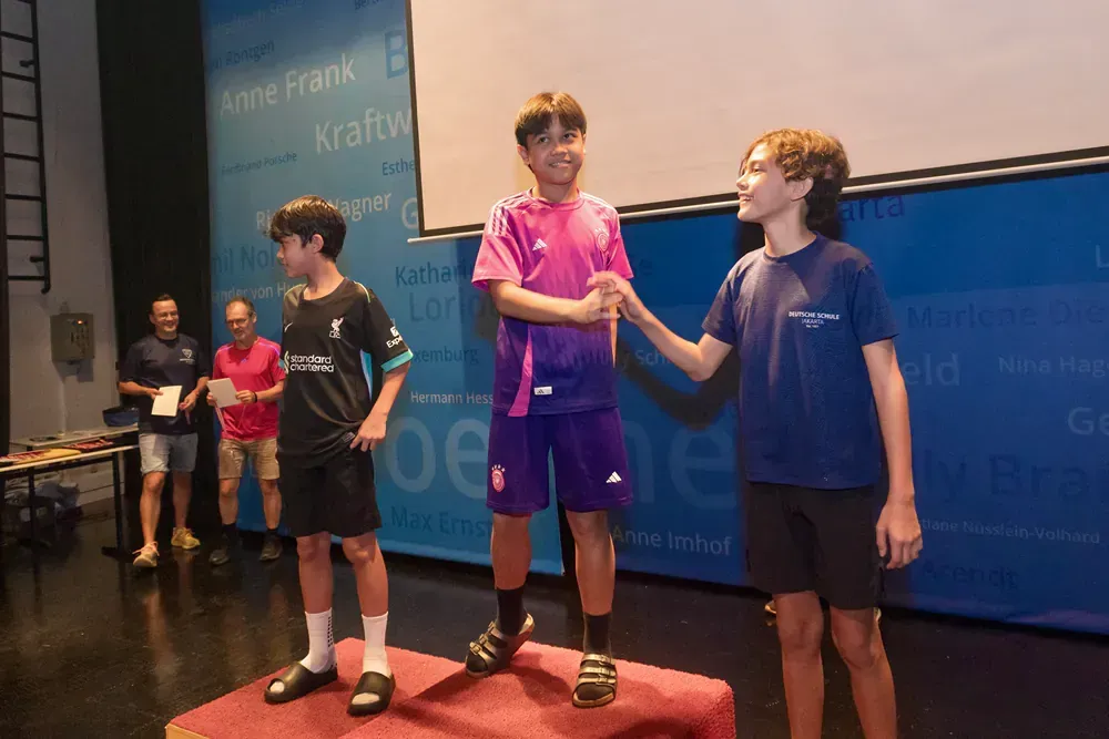 A group of young boys are standing on a podium.