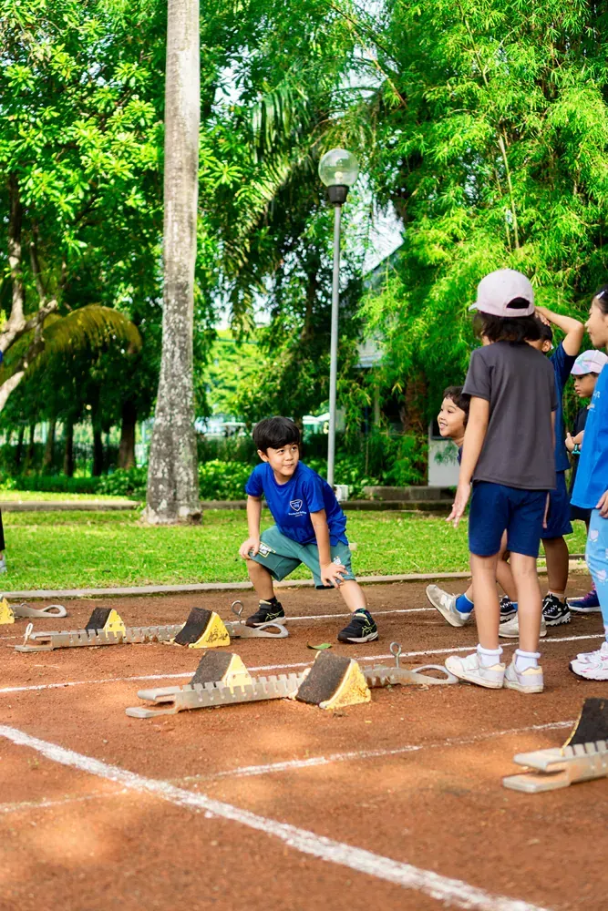A group of children are playing on a track in a park.