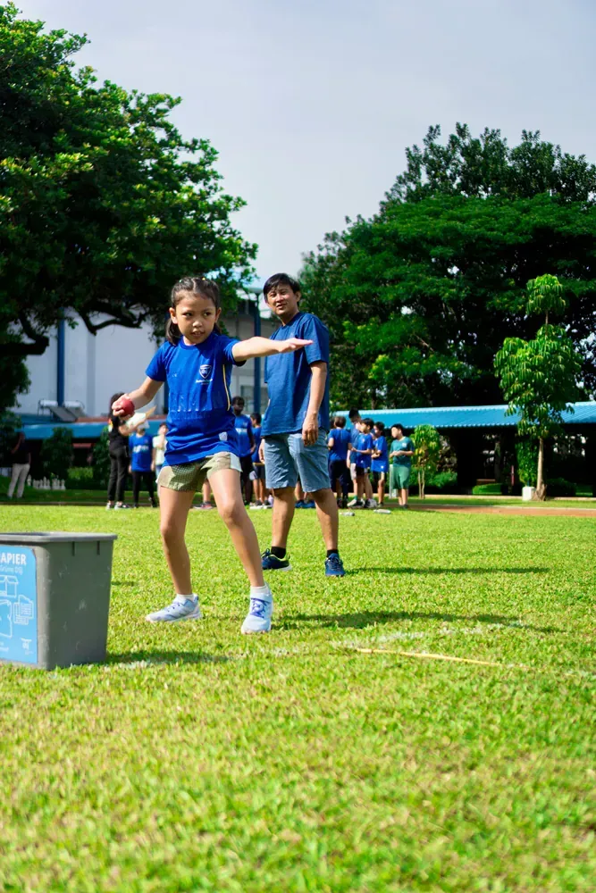 A group of children are playing a game on a lush green field.