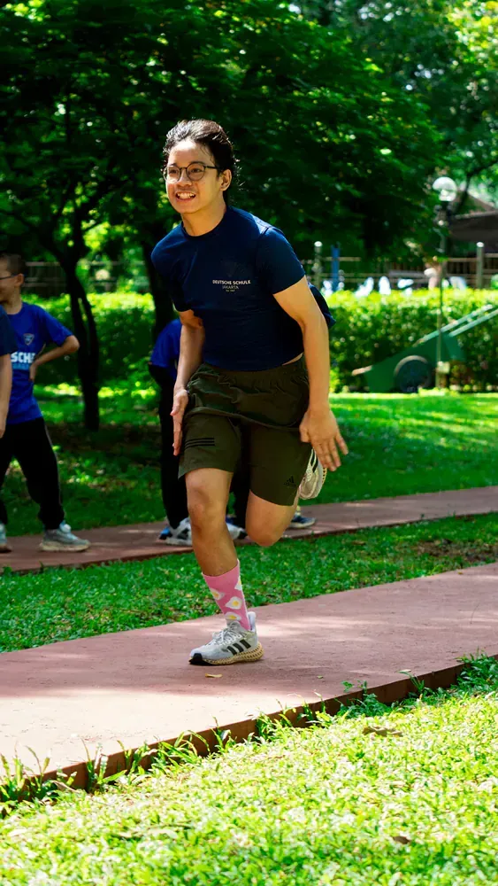 A man is running on a path in a park.