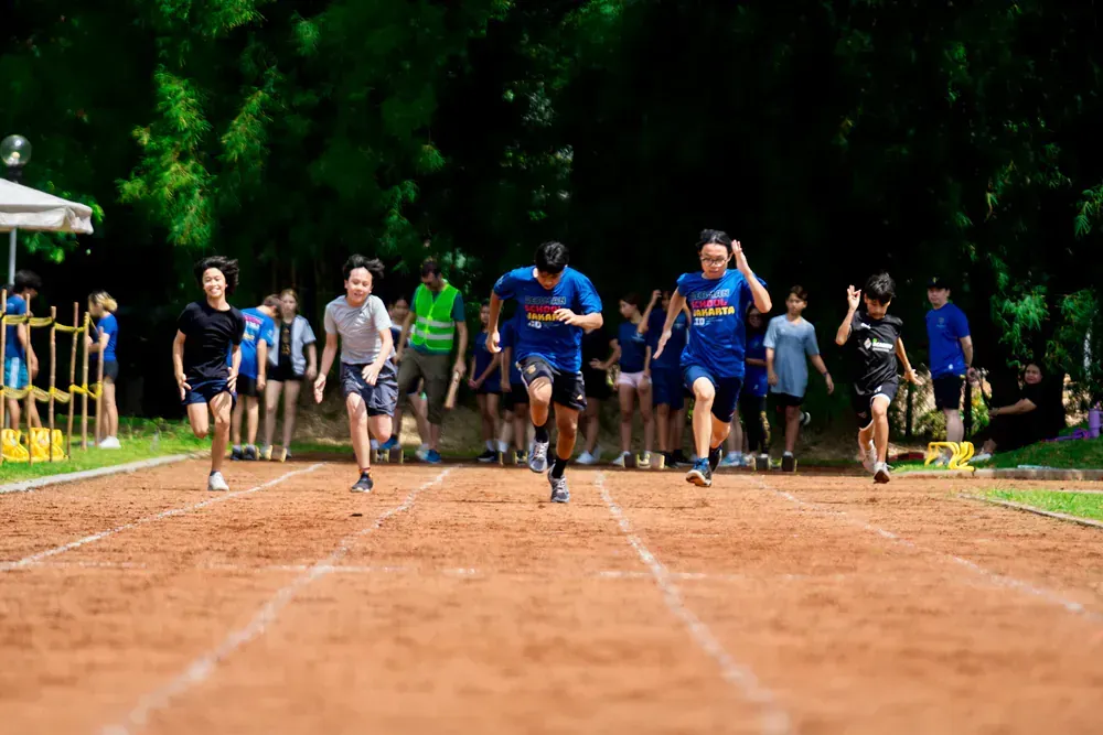 A group of people are running on a track.