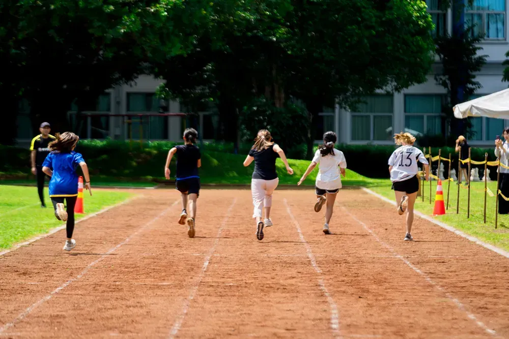A group of people are running on a track.