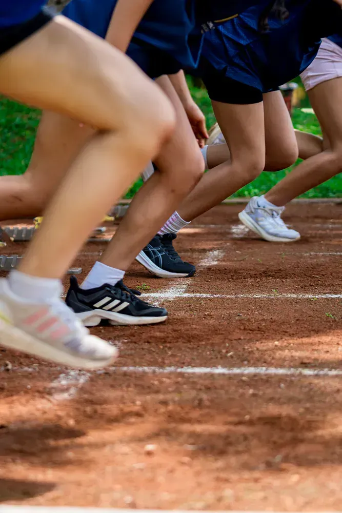 A group of people are running on a track.