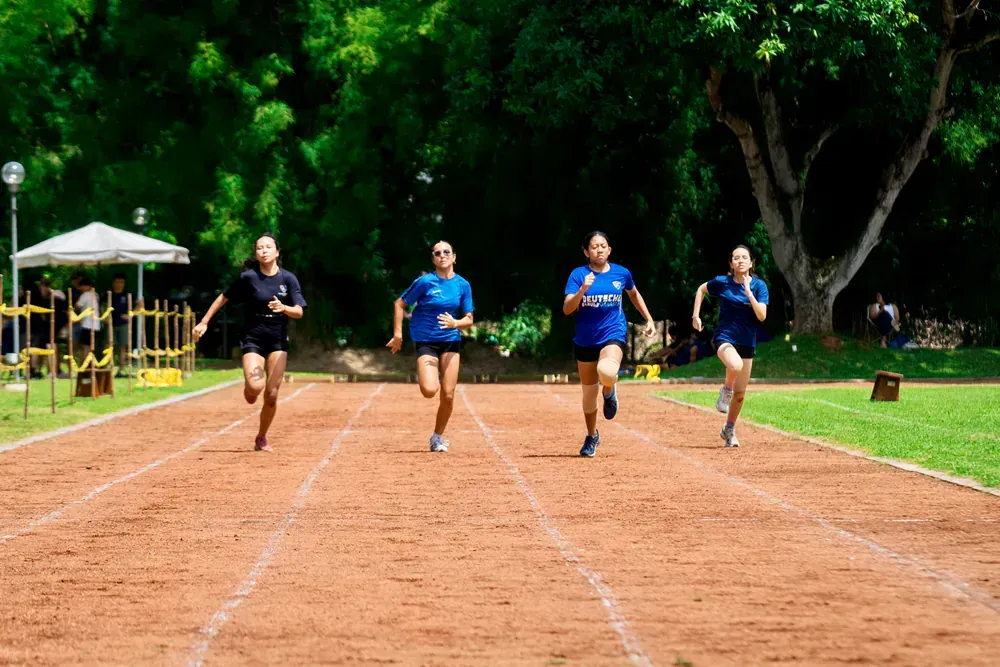 A group of young women are running on a track.