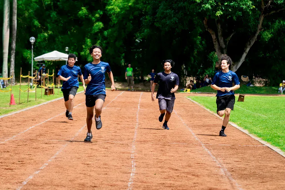 A group of people are running on a track.