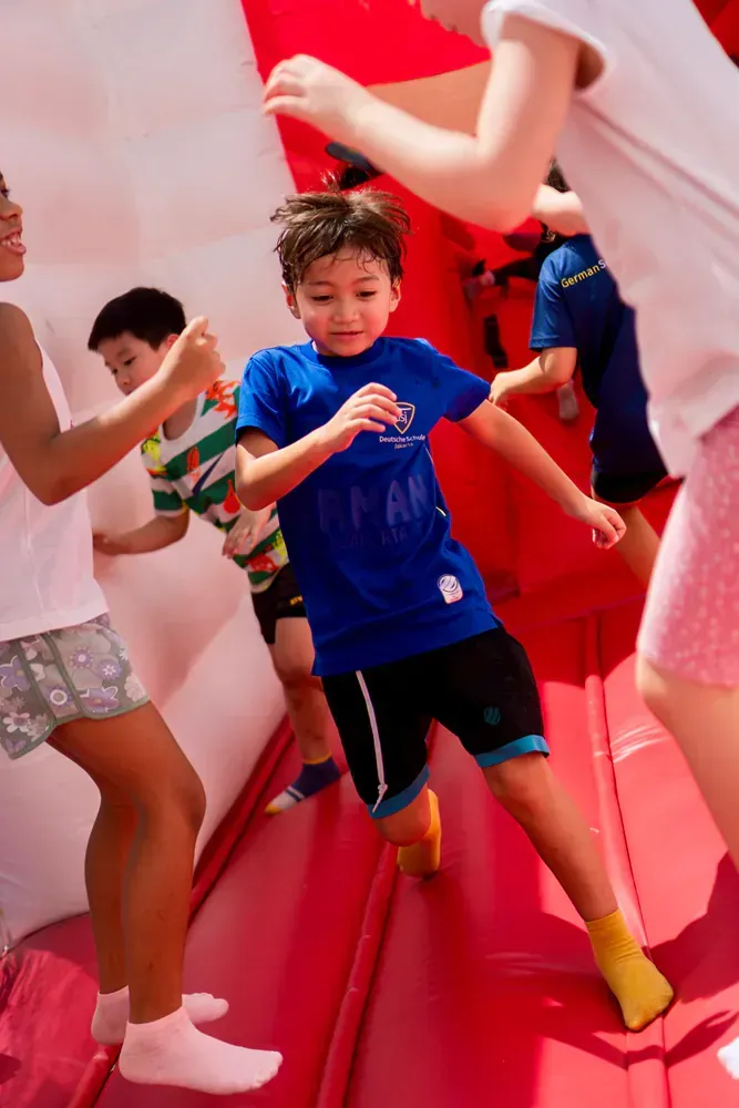 A group of children are playing in a bouncy house.