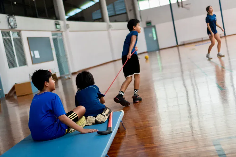 A group of children are playing a game in a gym.