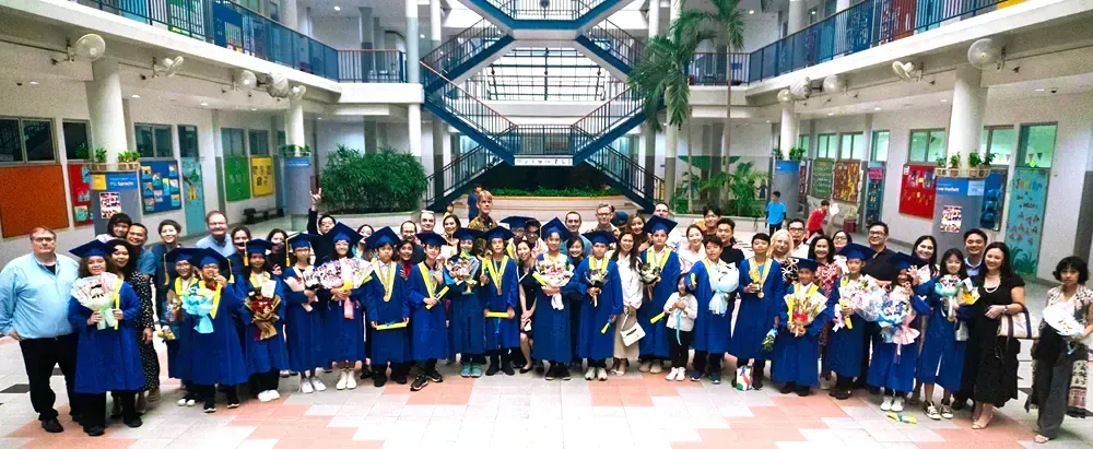 A large group of people are posing for a picture in a building