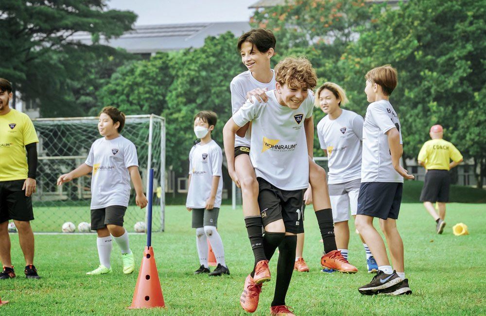 A group of young boys are playing soccer on a field.