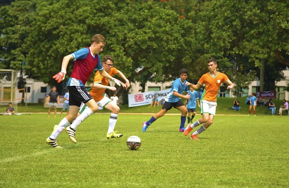 A group of young men are playing soccer on a field.