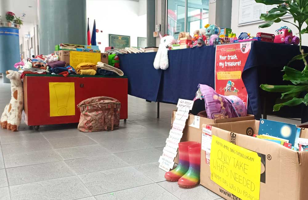 A table full of toys and a box that says ' donations ' on it