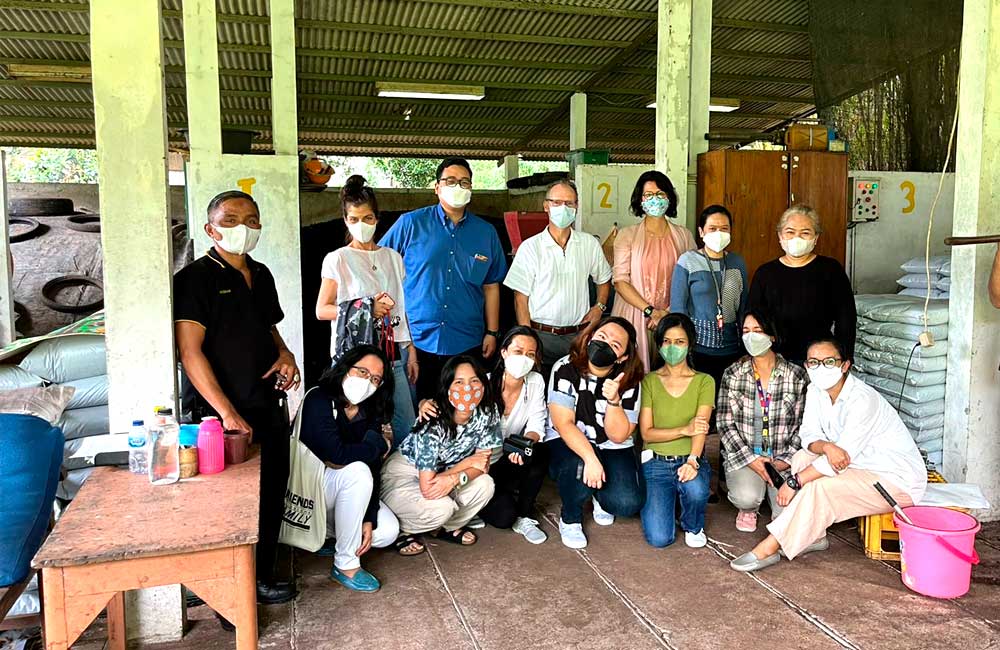 A group of people wearing face masks are posing for a picture.