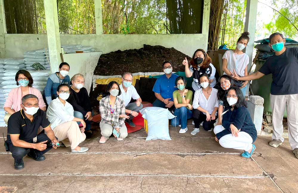 A group of people wearing face masks are posing for a picture.