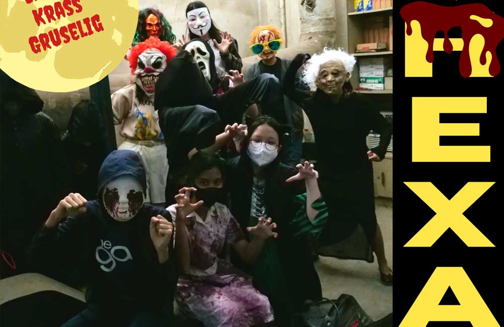 A group of people dressed in halloween costumes are posing for a picture.