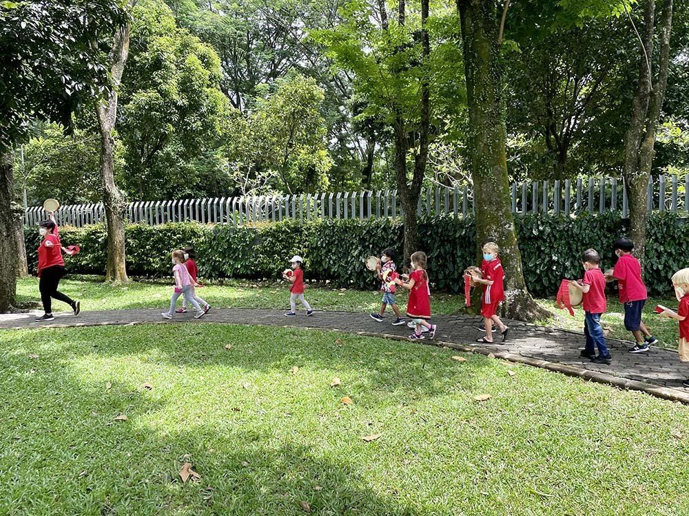 A group of children are walking in a park.