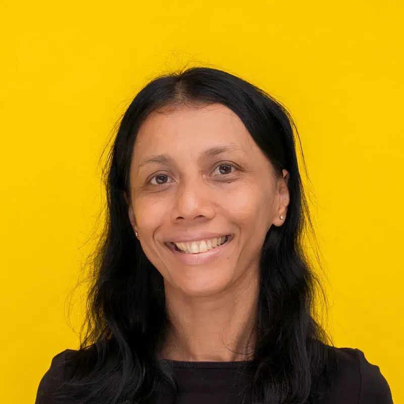 A young woman with short black hair is smiling for the camera.