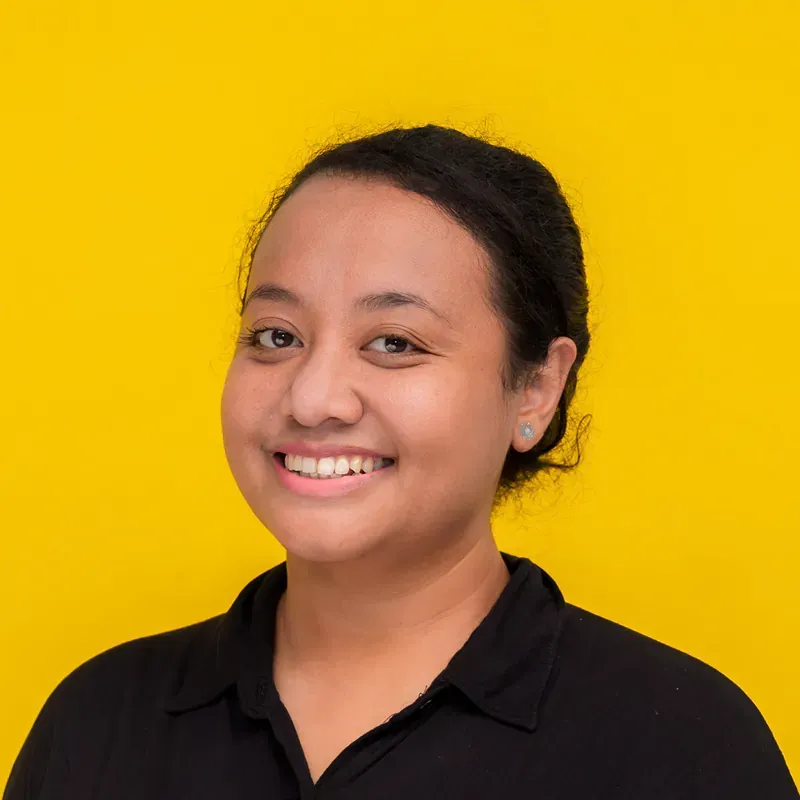 A young woman wearing a black turtleneck is smiling for the camera.
