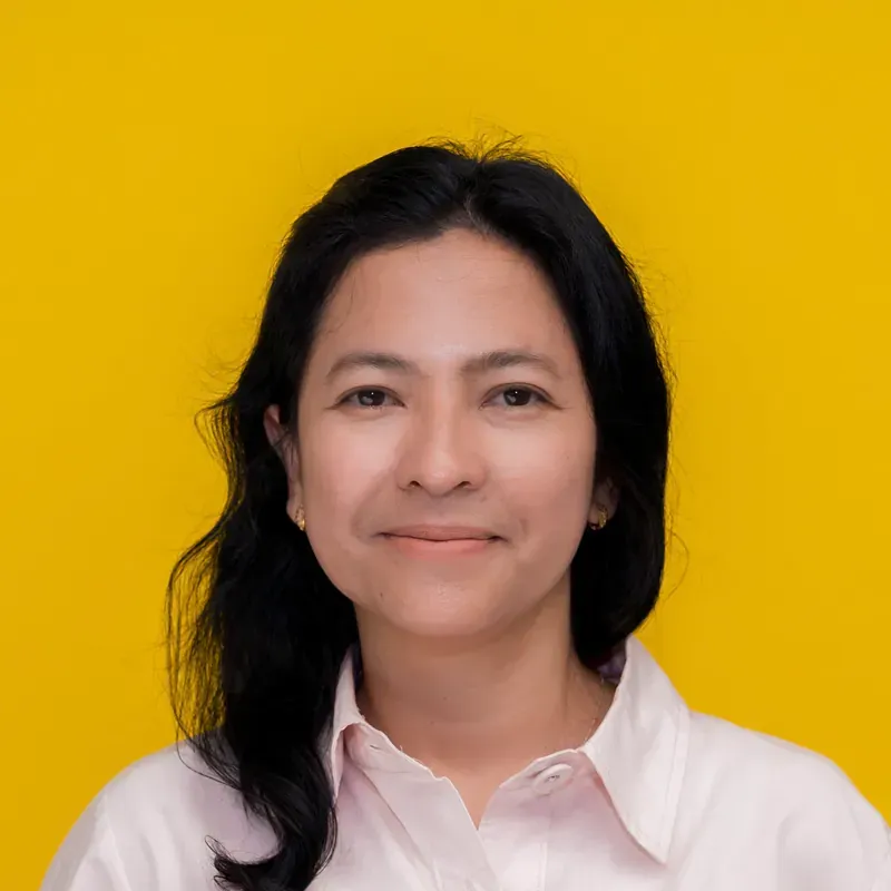 A woman with long hair is smiling and wearing a black shirt.