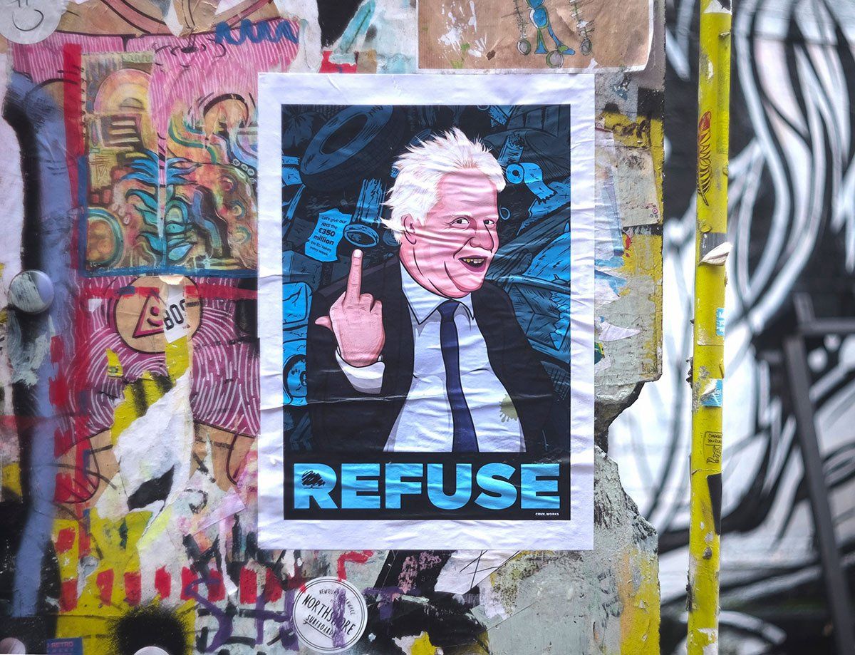 A sticker on a wall that says refuse on it
