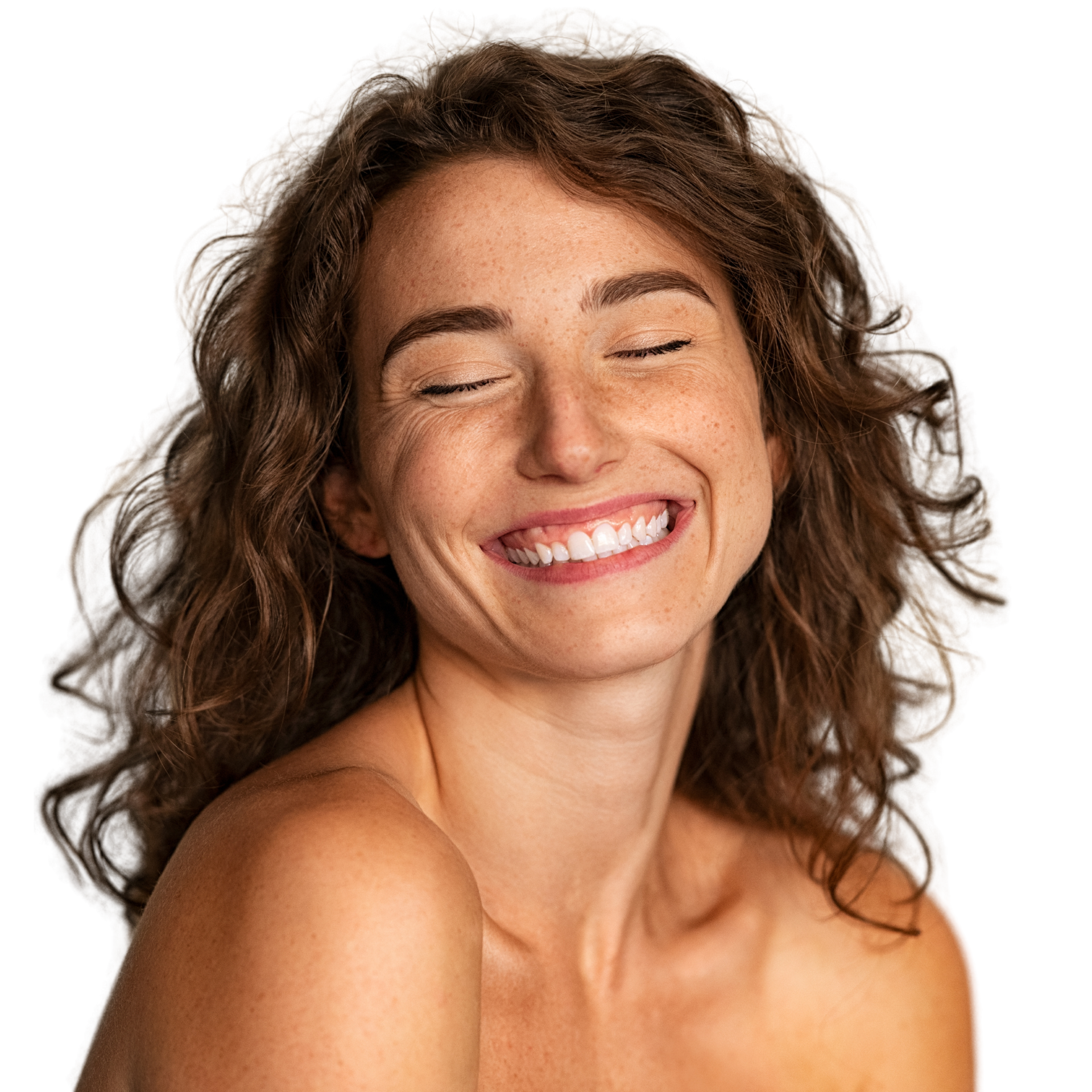 A woman with curly hair is smiling with her eyes closed.