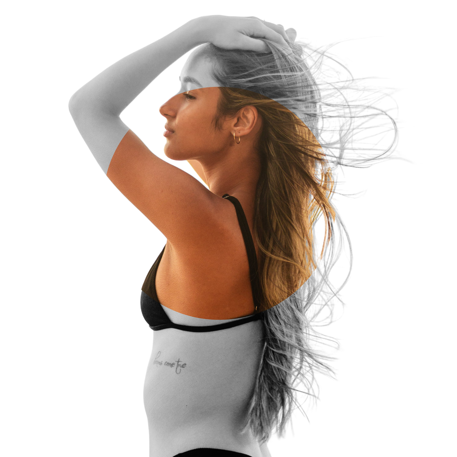 A woman with long hair has a tattoo on her side.