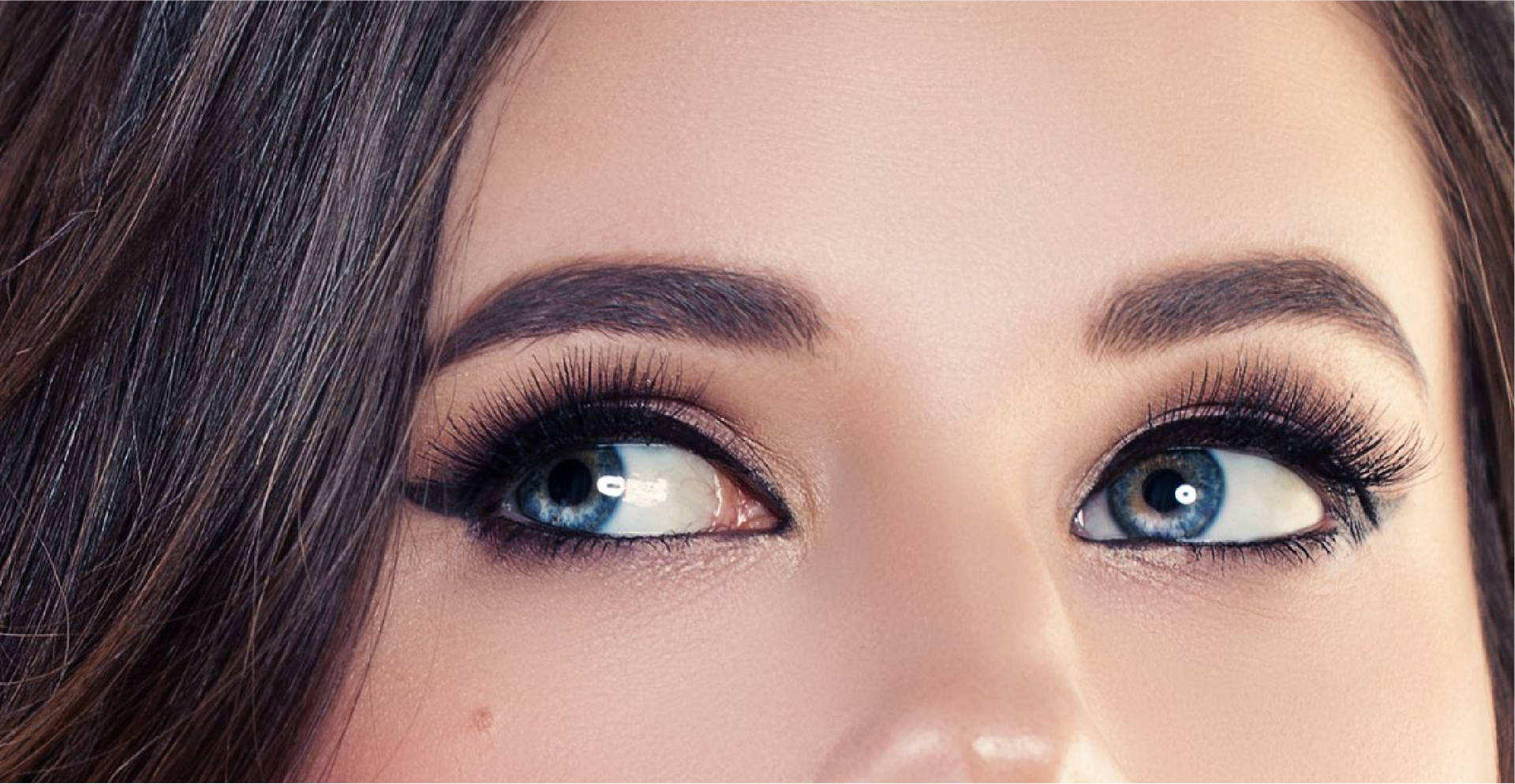 A close up of a woman 's blue eyes with makeup.