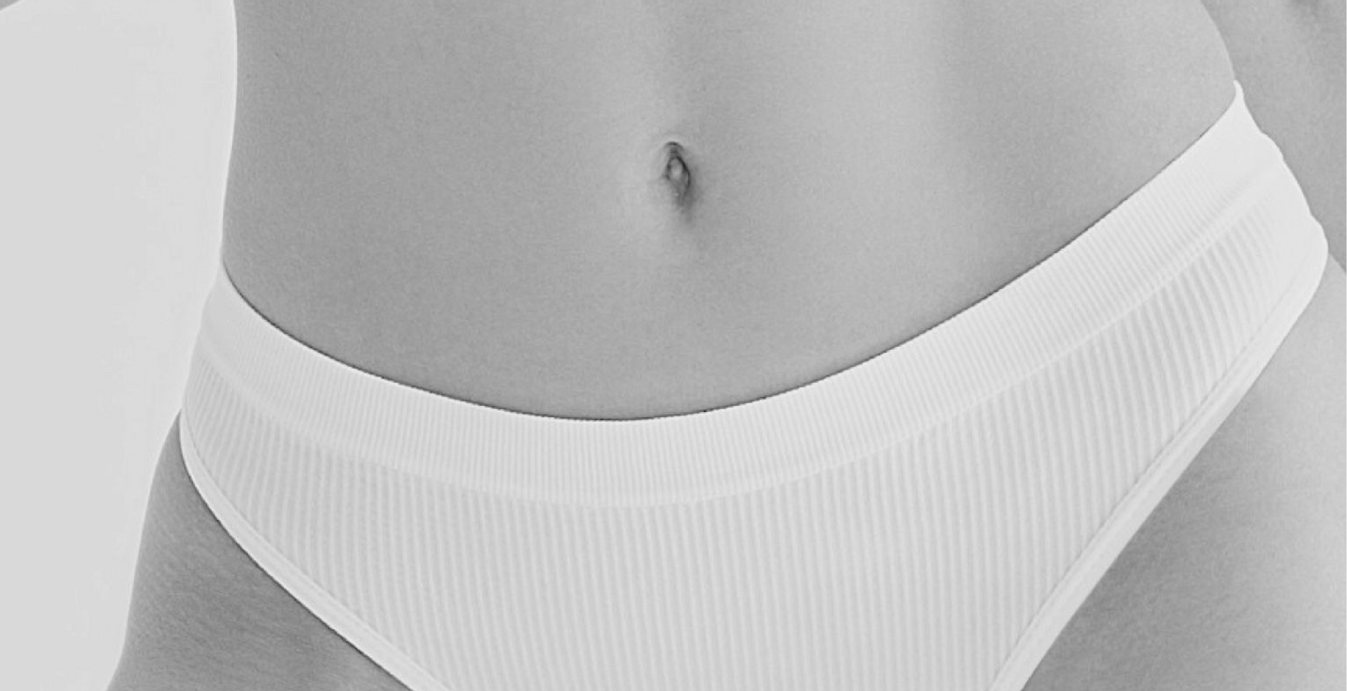 A woman 's stomach is shown in a black and white photo.