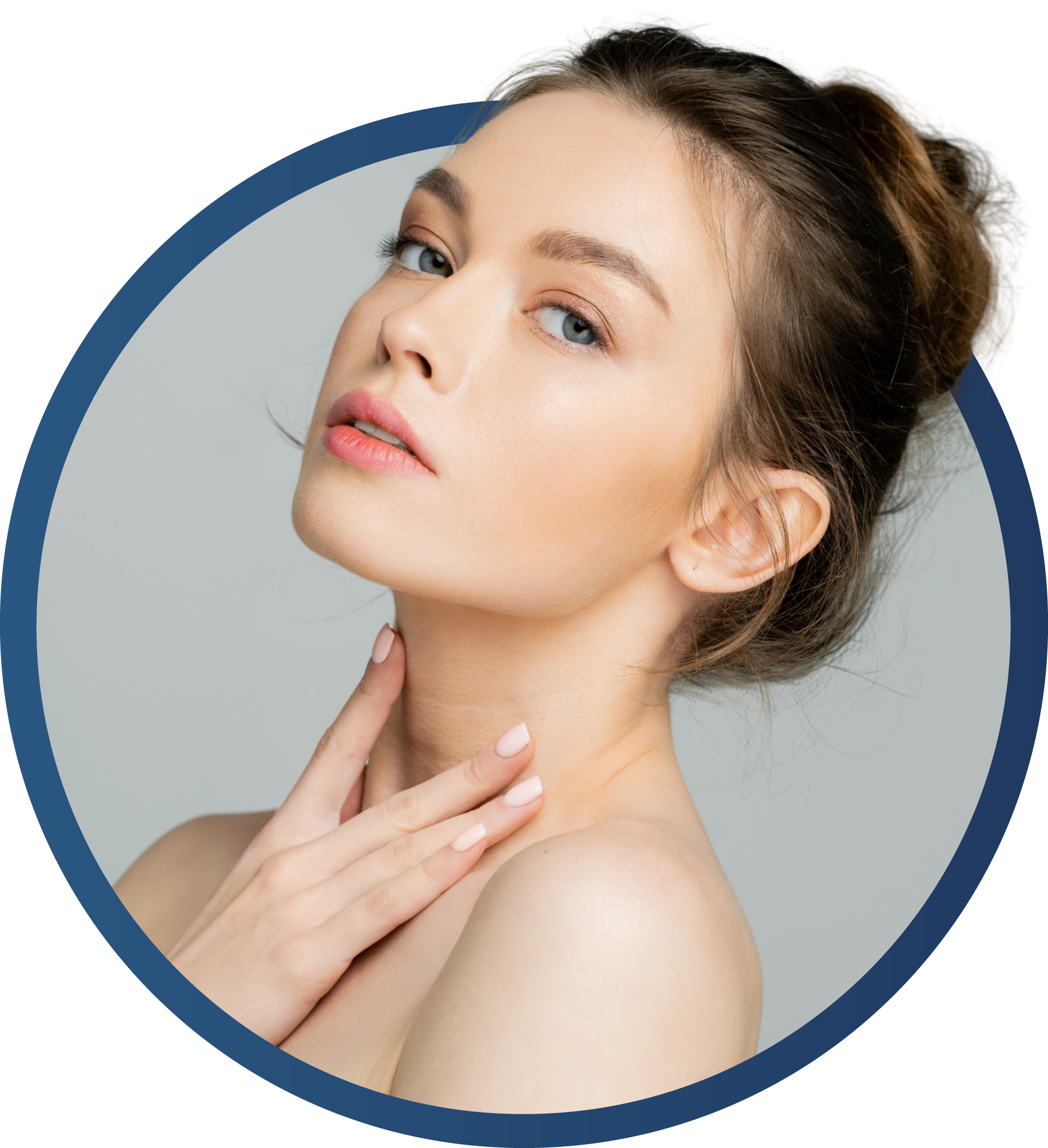 Woman touching her neck, looking up. Light skin, blue eyes, bun, neutral background.