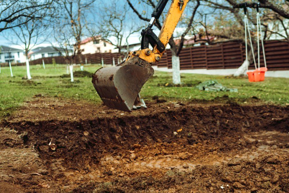 A Yellow Excavator Digging a Trench — Cairns Earthmoving Solutions In Redlynch, QLD