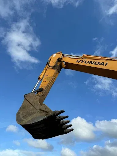 Yellow bobcat claw in the sky— Cairns Earthmoving Solutions In Holloways Beach, QLD