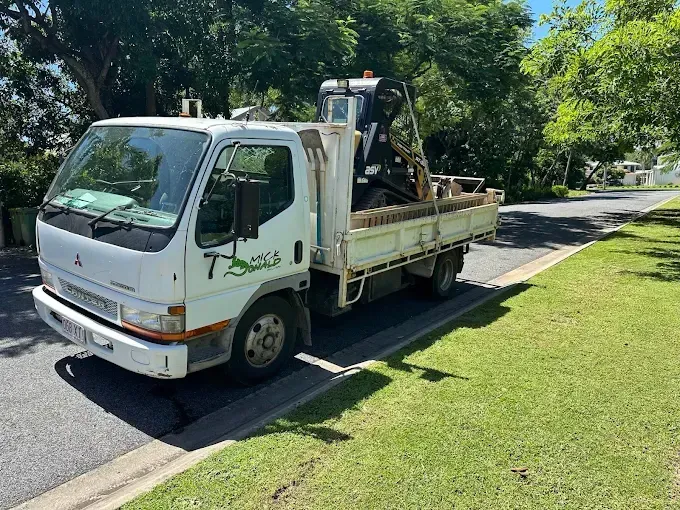 White truck with machine in the tray— Cairns Earthmoving Solutions In Gordonvale, QLD
