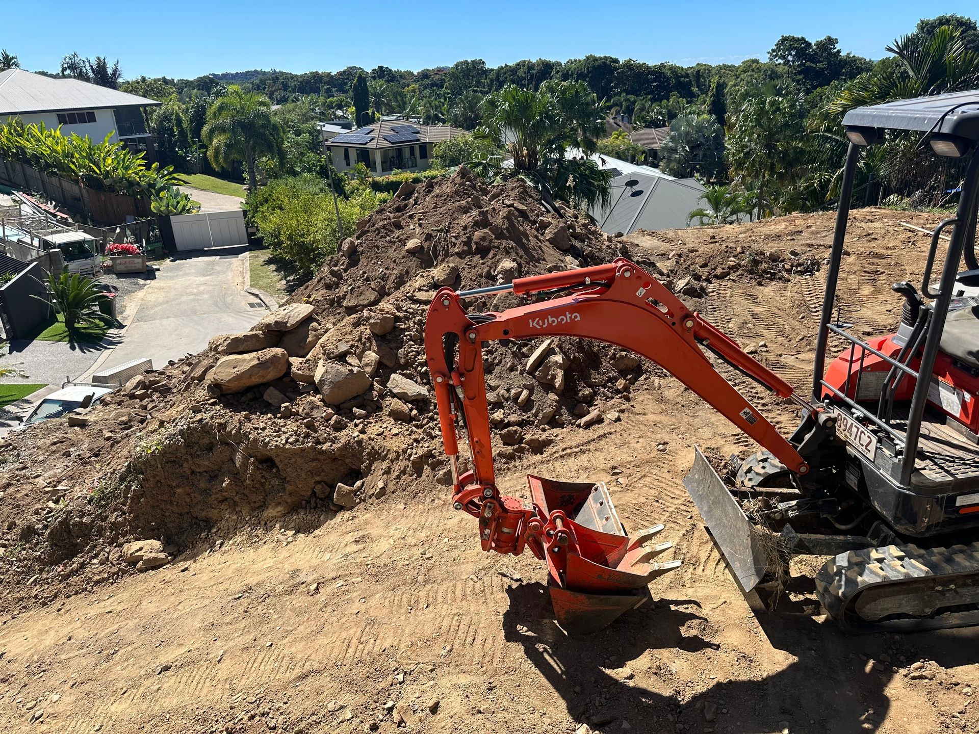 A Red Excavator on a Construction Site — Cairns Earthmoving Solutions In Smithfield, QLD