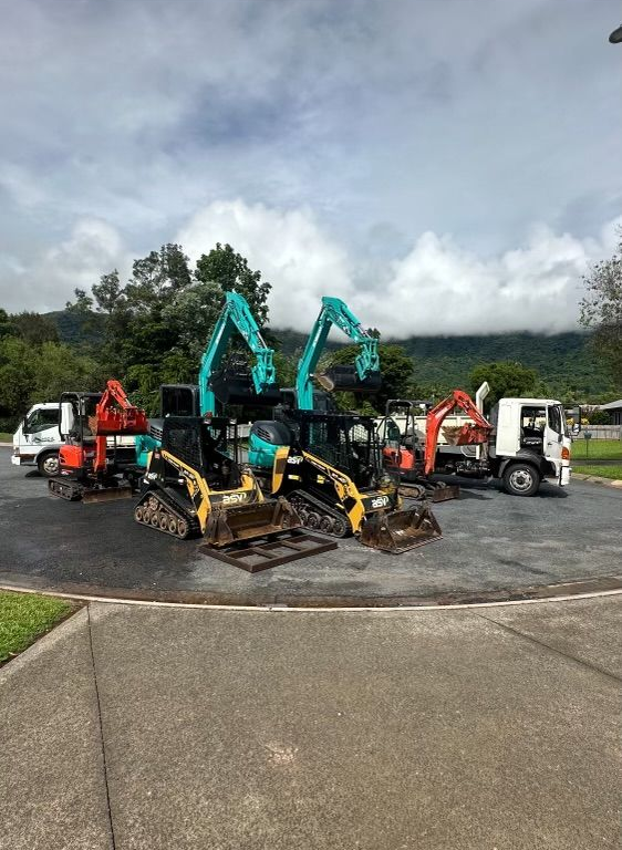 multiple excavators on a gravel road — Cairns Earthmoving Solutions In Smithfield, QLD