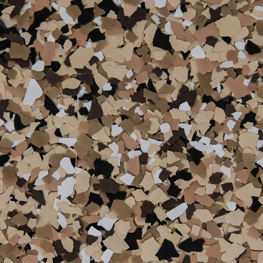 Scattered beige, brown, and black confetti-like paper pieces filling the frame.