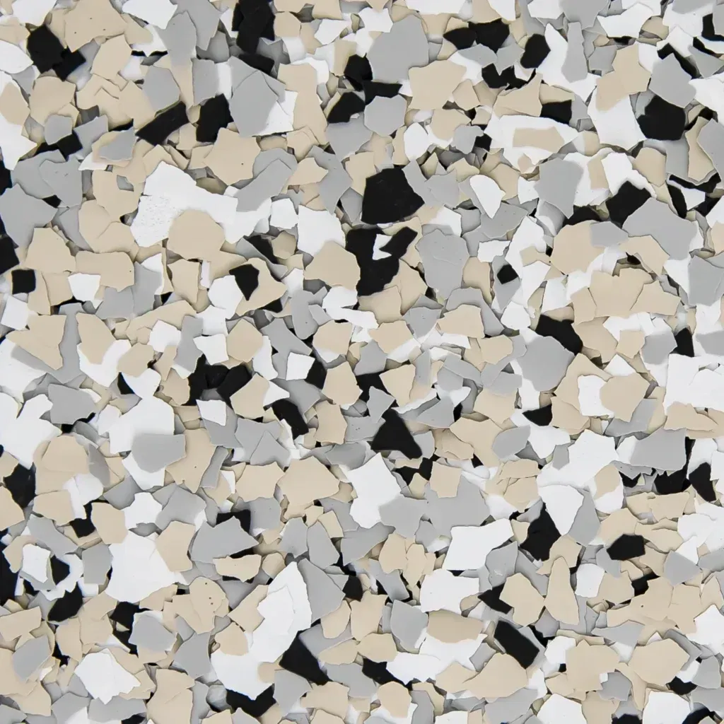 Close-up of scattered beige, white, and black pebbles or terrazzo chips in a textured pattern