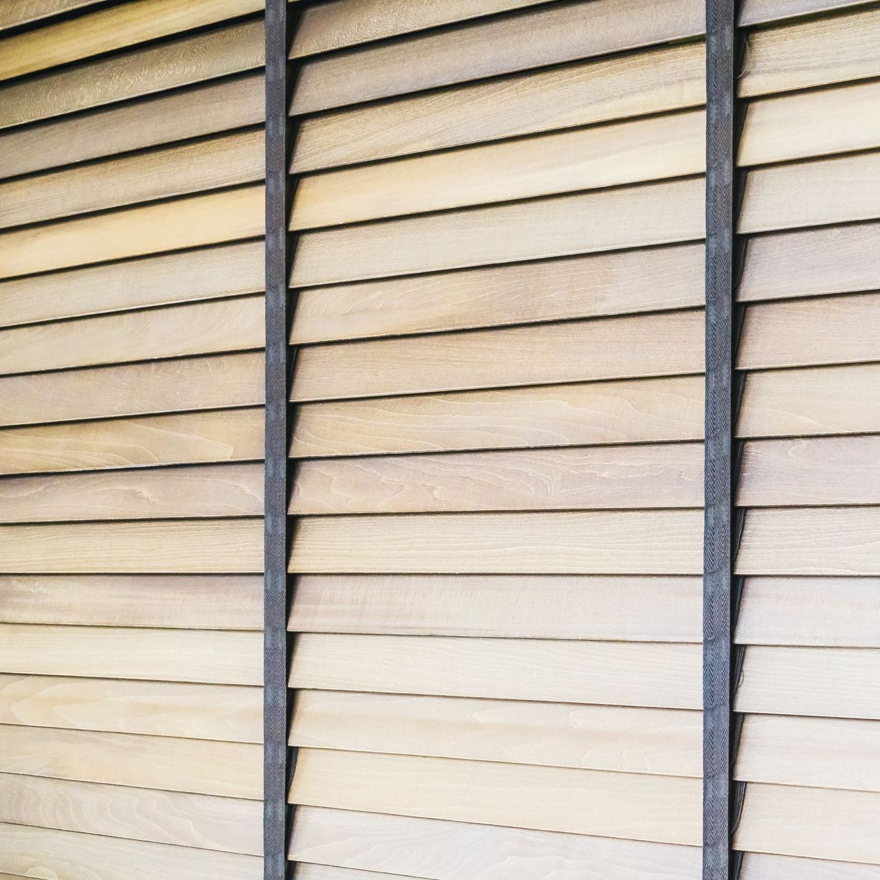 A close up of a wooden blind on a window