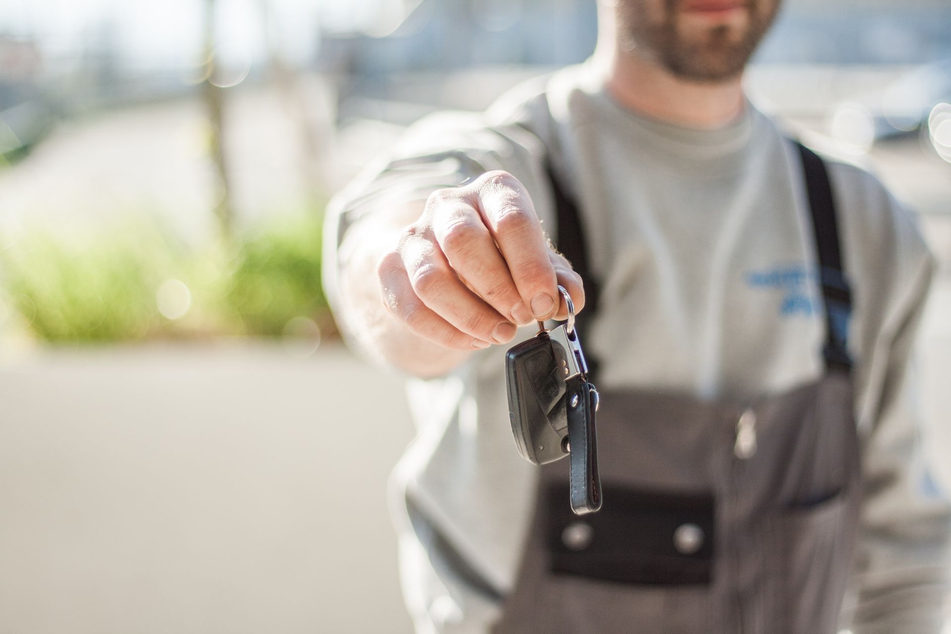 A man is looking at a car in a car showroom.