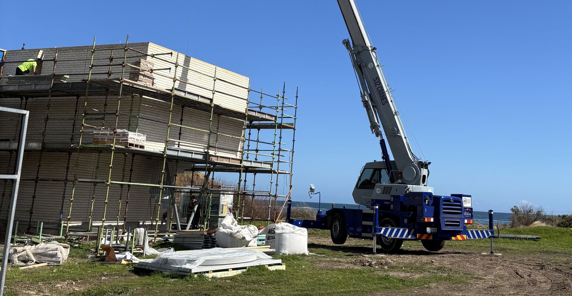 Crane positioning industrial equipment on an Adelaide worksite