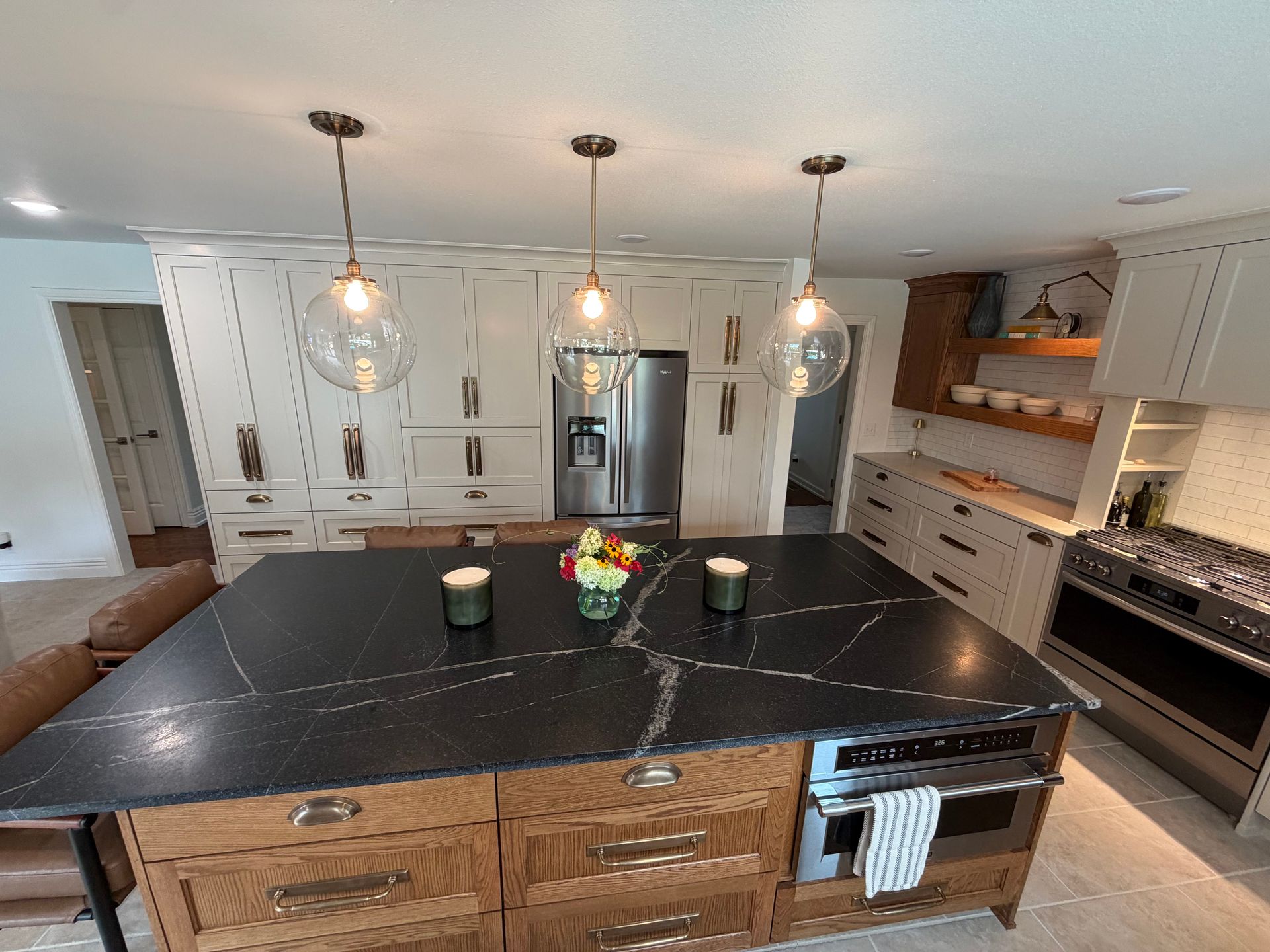Completed kitchen with white cabinets and gold details